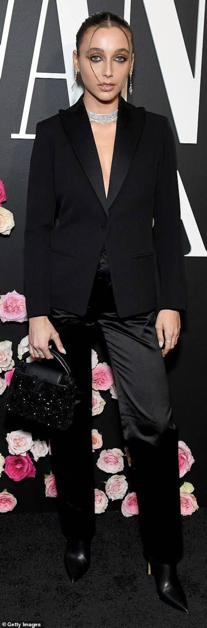 Modern muse:&nbsp;Emma Chamberlain leaned on recent trends by going topless beneath a black blazer and strutting her stuff on the carpet in pointed toe boots